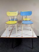 A mid 20th century melamine topped flap sided dining table and four harlequin melamine and tubular