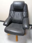 A Scandinavian swivel black leather armchair on pedestal