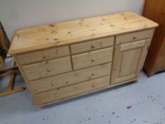 A stripped pine seven drawer chest fitted a cupboard