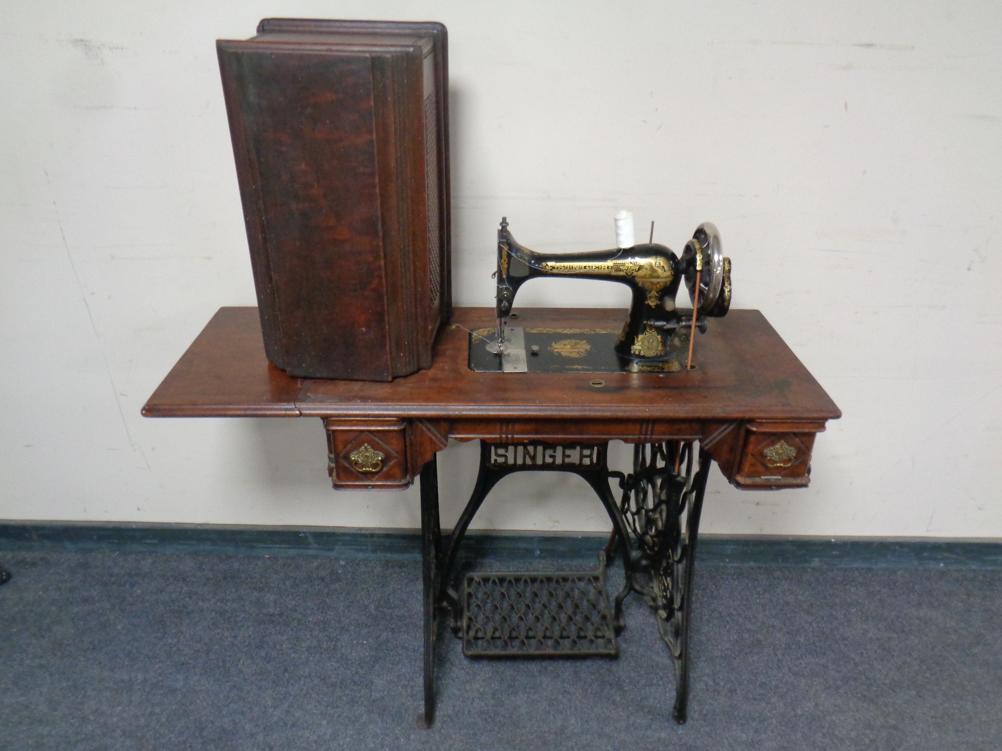 A Singer treadle sewing machine in mahogany table