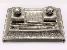 A Turkish silver embossed desk stand with twin inkwells and four silver pens