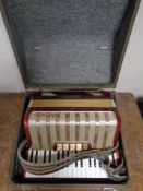 A Hohner piano accordion in case