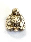 A Japanese carved netsuke depicting a turtle family, length 42 mm.