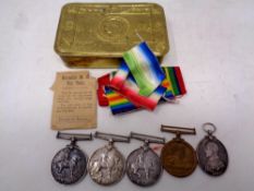 A Christmas 1914 brass tin containing;