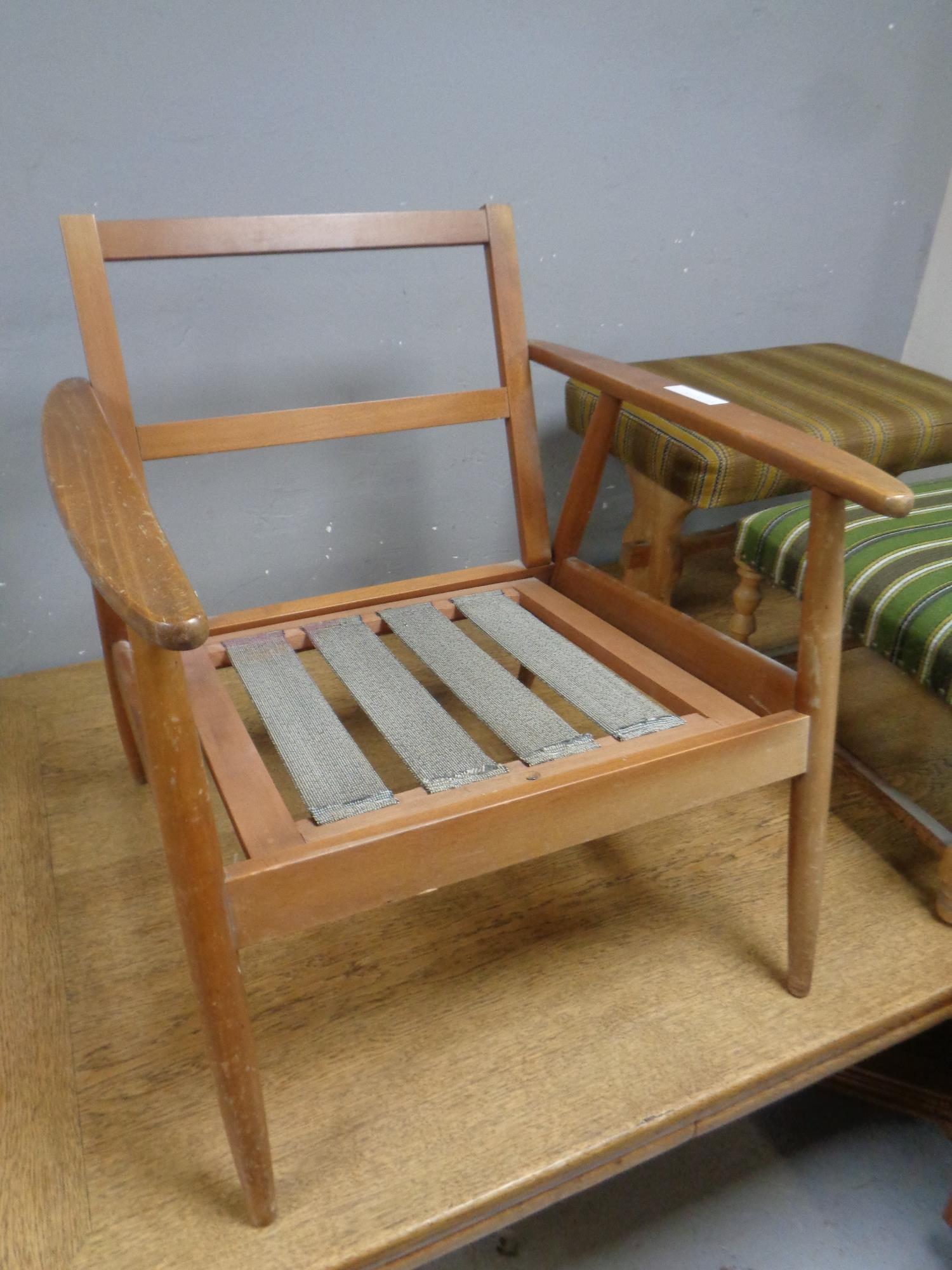 A mid 20th century teak armchair (no cushions)