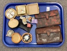A tray containing travel clocks, leather wallets,