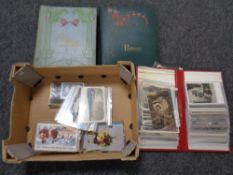 A box of quantity of vintage postcards albums and postcards inc.