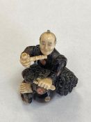 A carved Ivory netsuke depicting a Gentleman with pipe, height 45 mm.
