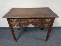 A George III and later carved five drawer oak low boy,