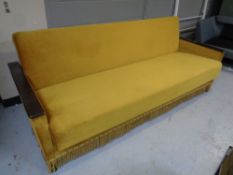 A mid century bed settee in golden fabric