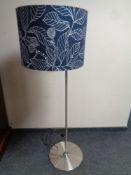 A contemporary standard lamp with shade