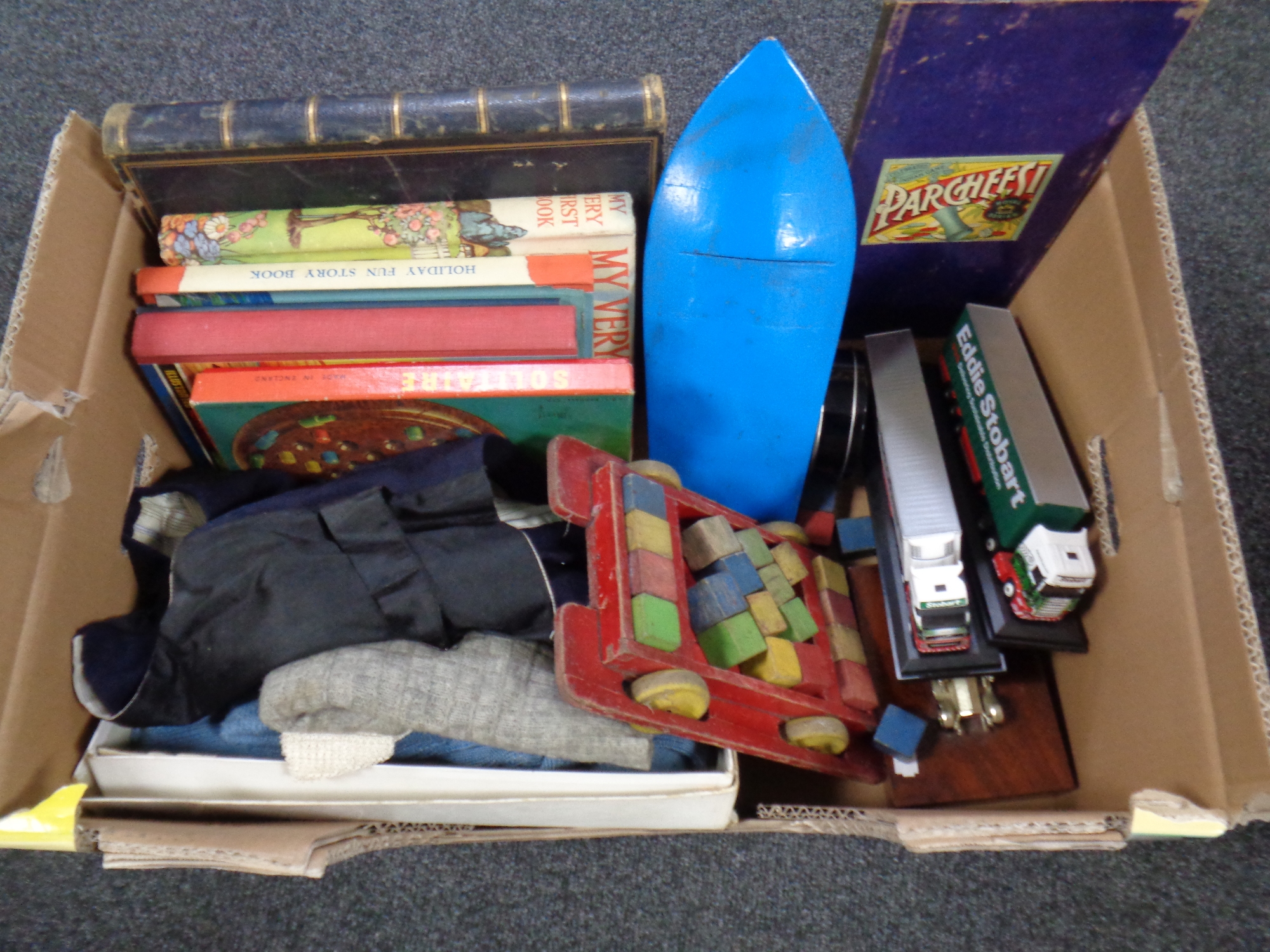 A box of mid 20th century toys, children's clothing, annuals,