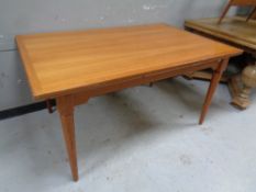 An Hoffer rectangular extending dining table together with three bentwood elbow chairs