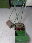 A vintage Monitor Push lawn mower with grass box together with further garden roller