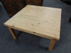A stripped pine square coffee table