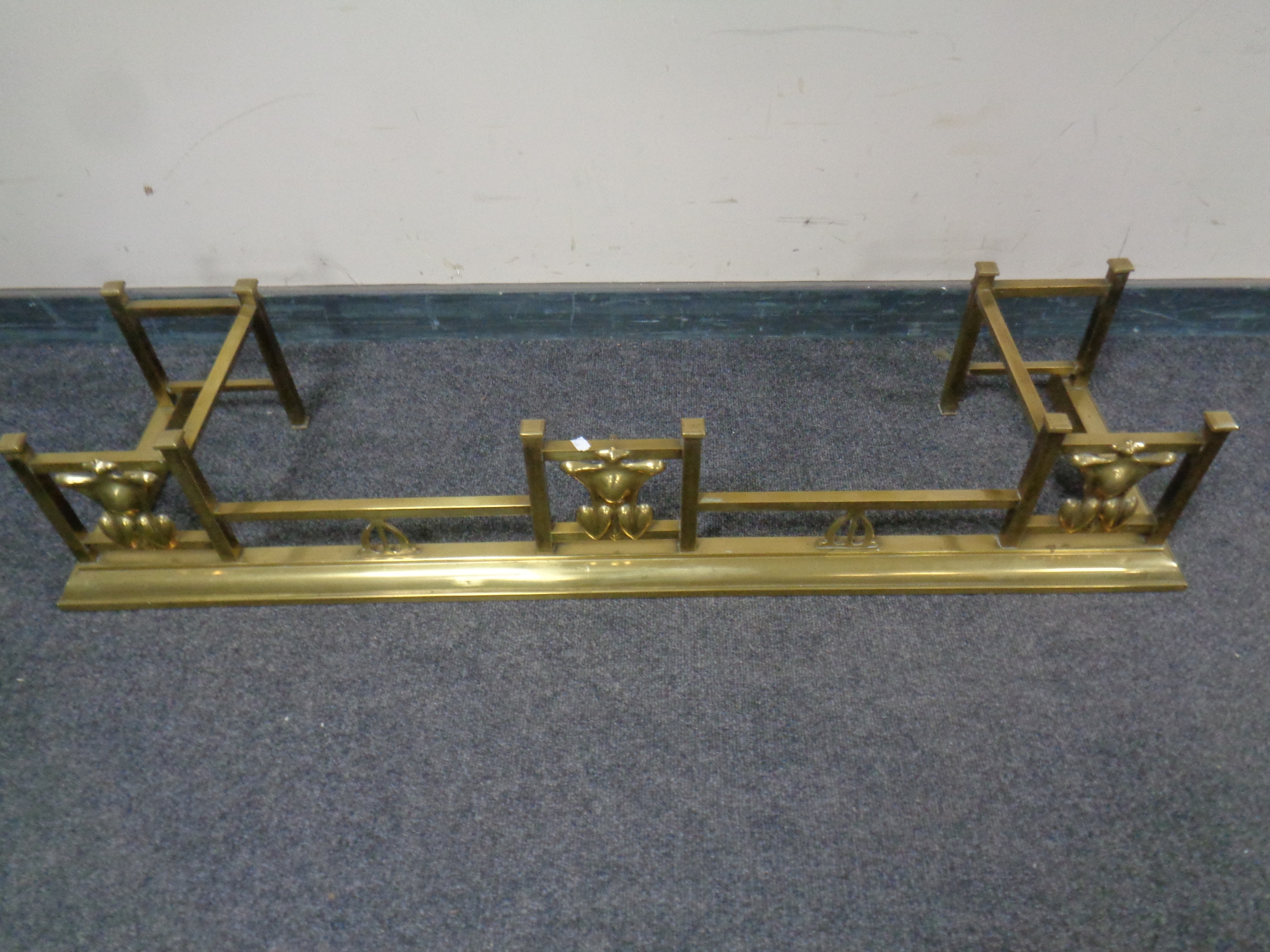 A brass Art Nouveau fire curb