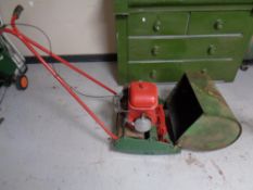 A vintage Suffolk Punch model 21A petrol lawn mower with grass box and roller
