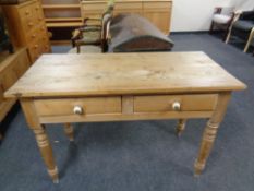 A pine kitchen table fitted two drawers