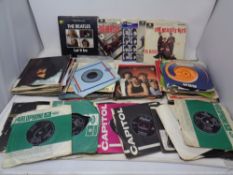 A crate of a quantity of vinyl 7" singles and EP's to include many by The Beatles to include Lady