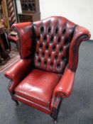 A Chesterfield red button leather wingback armchair