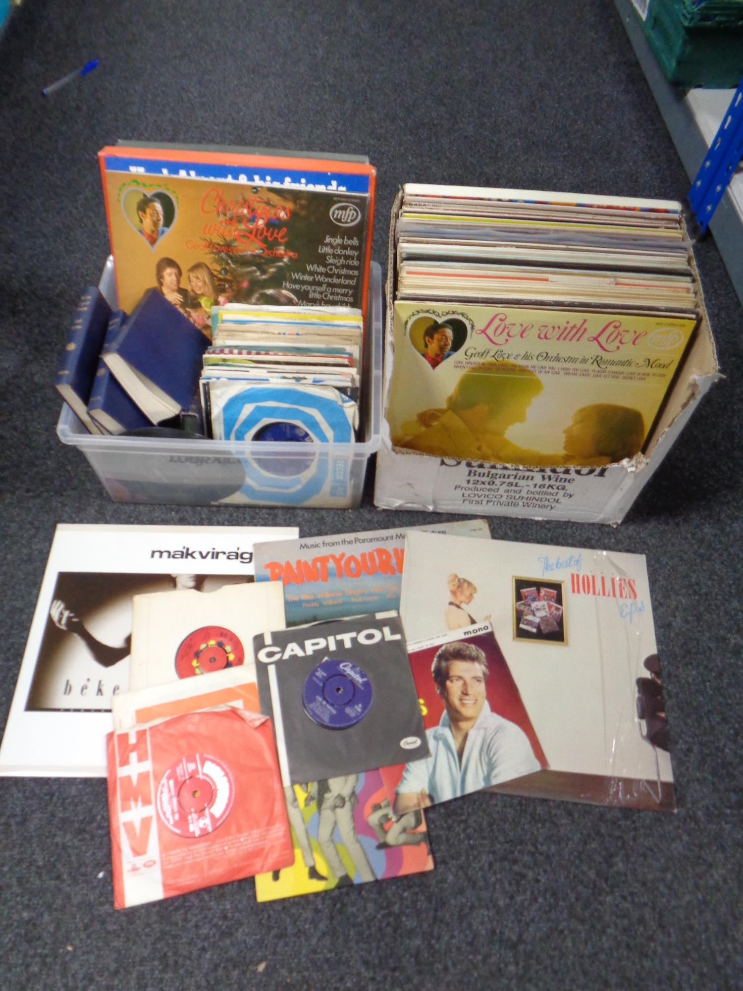 Two boxes of vinyl LP records, 7" singles and books to include The Hollies, opera,