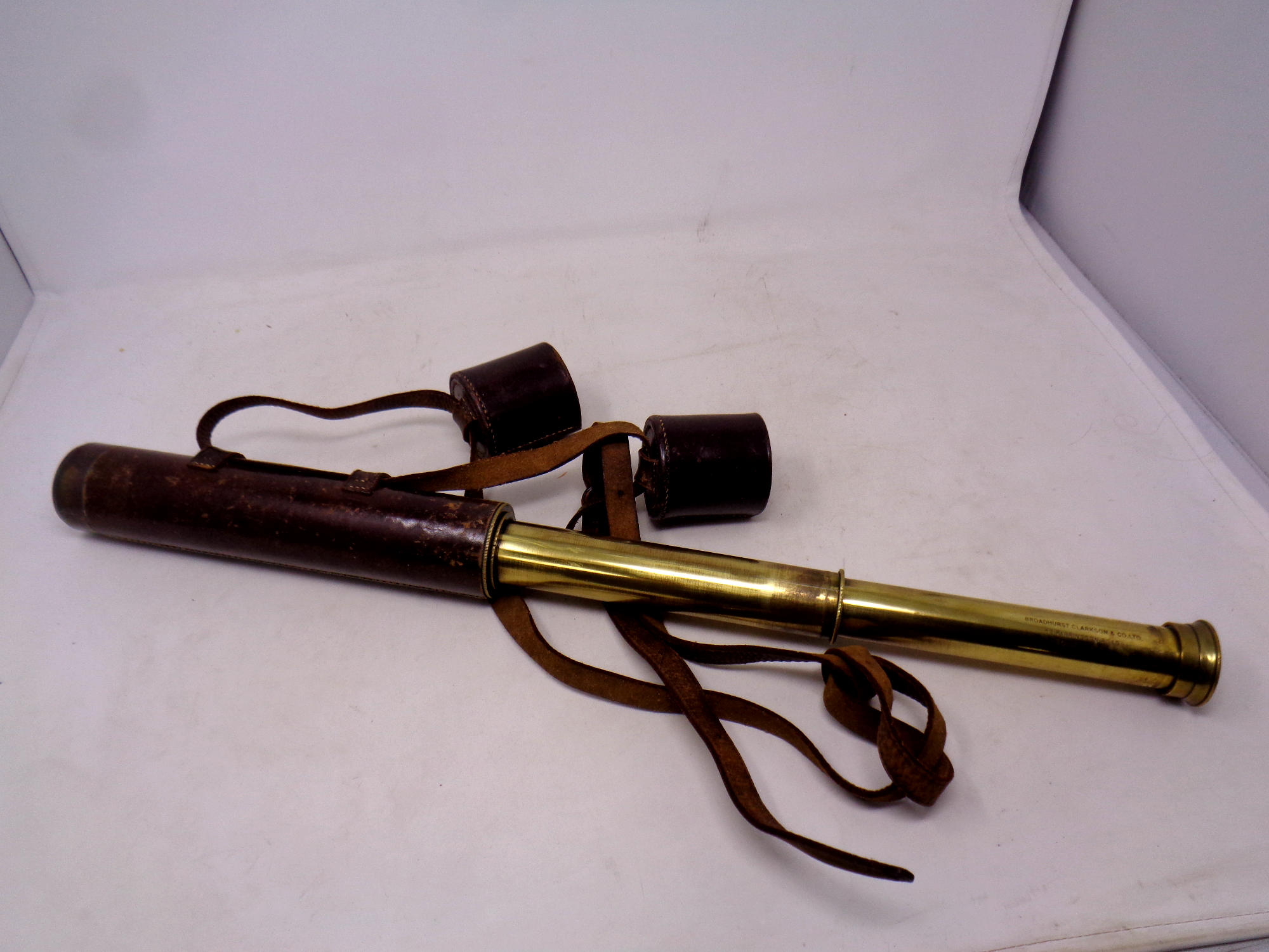 An leather cased antique brass nautical telescope