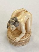 A carved Japanese netsuke erotic study, signed to base, height, 35 mm.