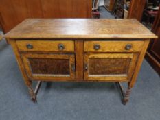 An Edwardian oak sideboard on barley twist legs