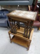 An oak two tier tea trolley together with a nest of three oak tile top tables