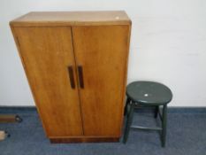 A 20th century oak double door cabinet and a painted kitchen stool