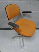 A twentieth century Scandinavian swivel chair in burnt orange fabric