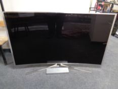 A Samsung SU HD 65'' curved TV with lead and remote CONDITION REPORT: Screen fault.