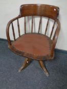 An Edwardian oak captain's desk chair