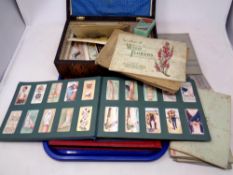 A tray of 19th century inlaid jewellery box of antique and later postcards,