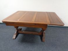 An Edwardian oak pull out dining table together with twelve harlequin 19th and 20th century dining