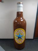 A large plastic Newcastle Brown Ale advertising bottle,