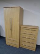 A contemporary double door wardrobe fitted with two drawers together with matching five drawer
