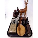 A tray of carved hardwood Buddha table lamp, carved stone African busts, dressing table mirrors,