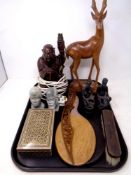 A tray of carved hardwood Buddha table lamp, carved stone African busts, dressing table mirrors,