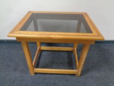 An oak smoked glass topped coffee table