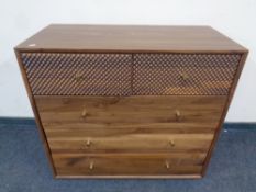 A contemporary five drawer chest in oak finish