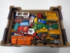 A box of mid century and later play worn die cast vehicles including Matchbox trucks,