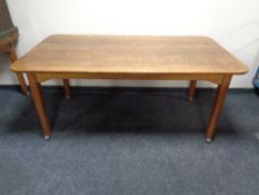 An Edwardian oak table on castors, length 168 cm x width 90 cm.