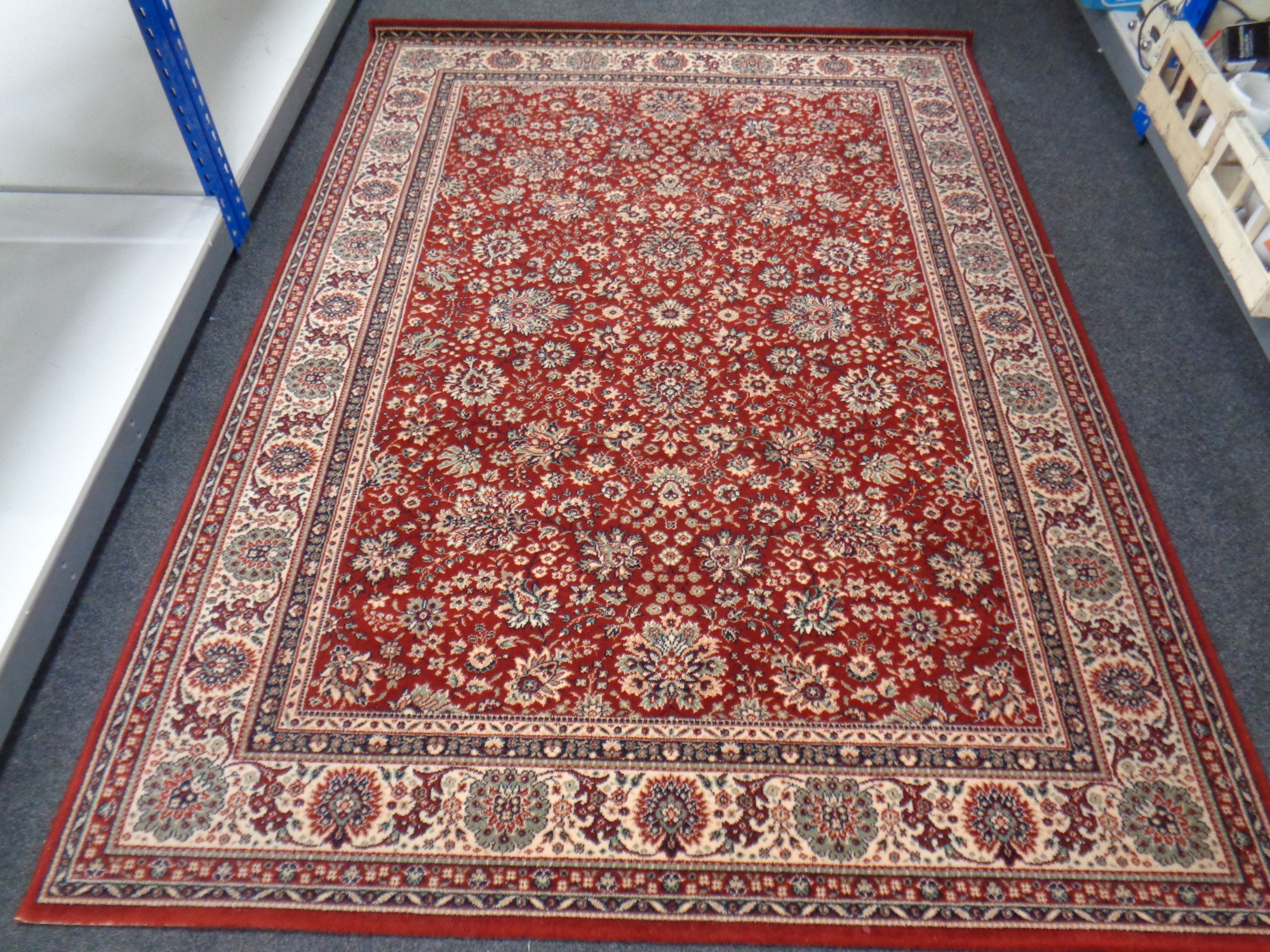 A machined Persian design rug on red ground