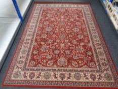 A machined Persian design rug on red ground