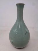 An Oriental celadon vase decorated with Storks in flight, mark to lower edge, height 17 cm.