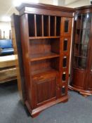 An Indonesian shelving unit fitted with cupboard and five drawers