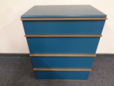 A contemporary four drawer chest in teal finish with teak handles