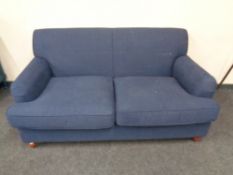 A Victorian style two seater settee in blue fabric