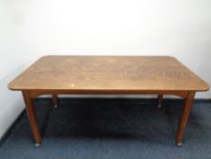 An Edwardian oak table on castors, length 168 cm x width 90 cm.